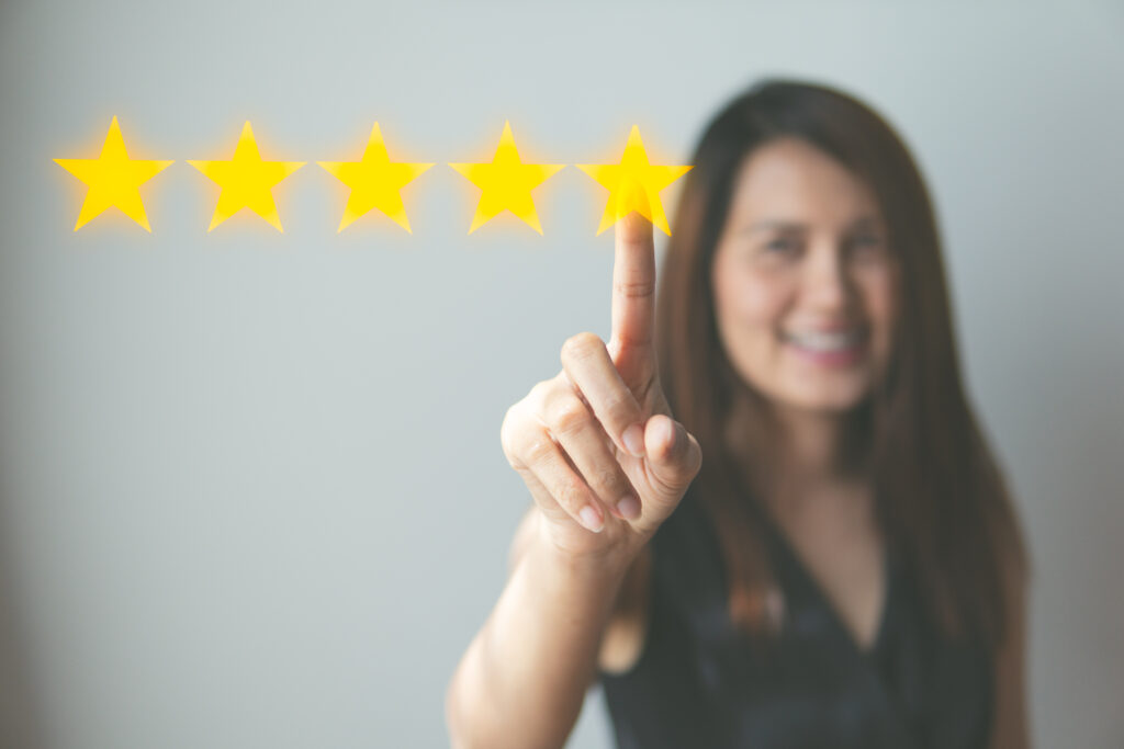 Customer review good rating concept hand pressing five star on visual screen and positive customer feedback testimonial.
